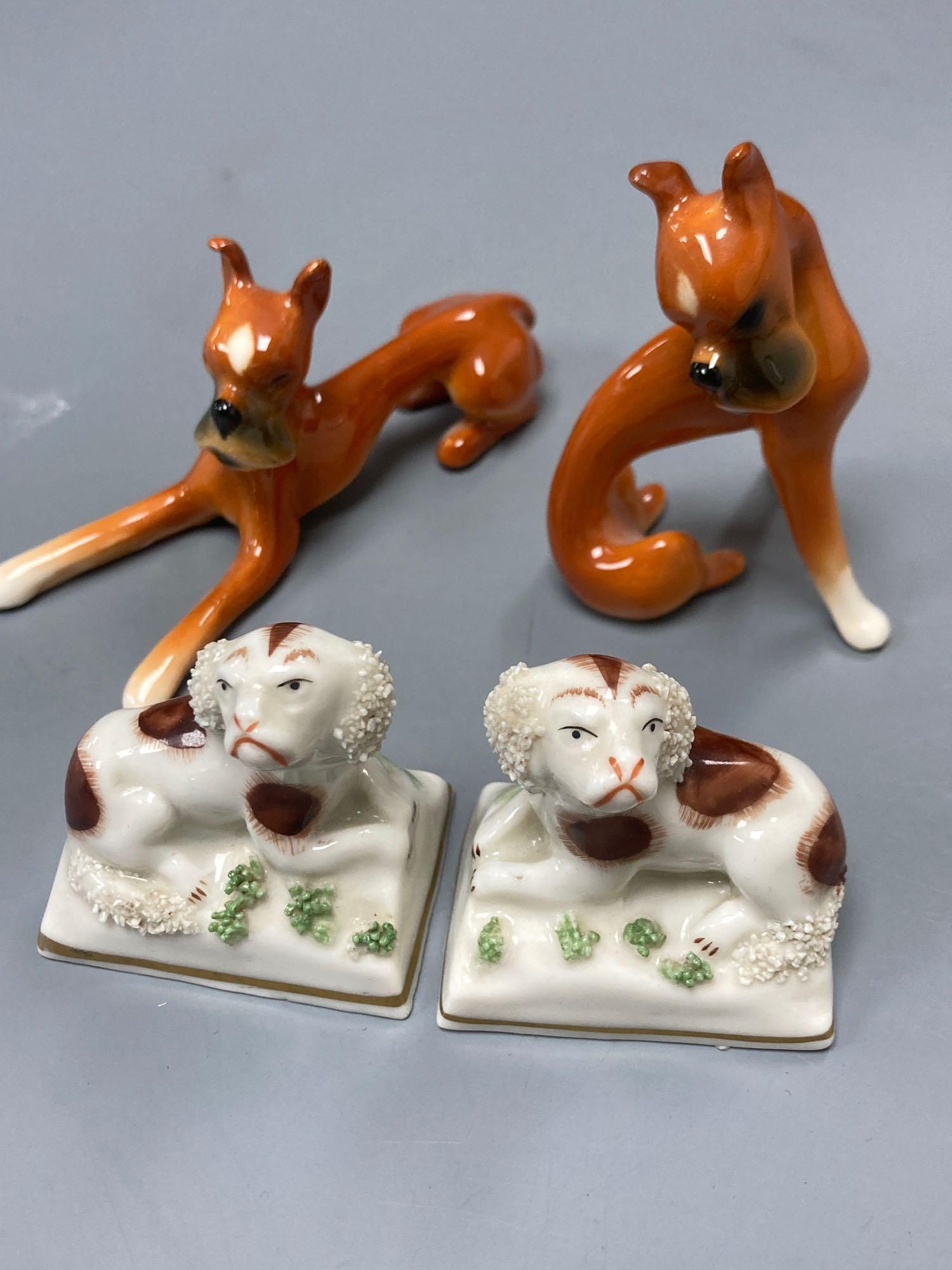 A pair of Goebel ceramic Dobermans, tallest 7.5cm and a pair of miniature Continental Spaniels, 5cm high